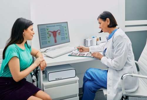 Consultation of gynecologist. Doctor and woman patient is talking in gynecological office during visit at gynecology office Infertility Counseling and Treatment